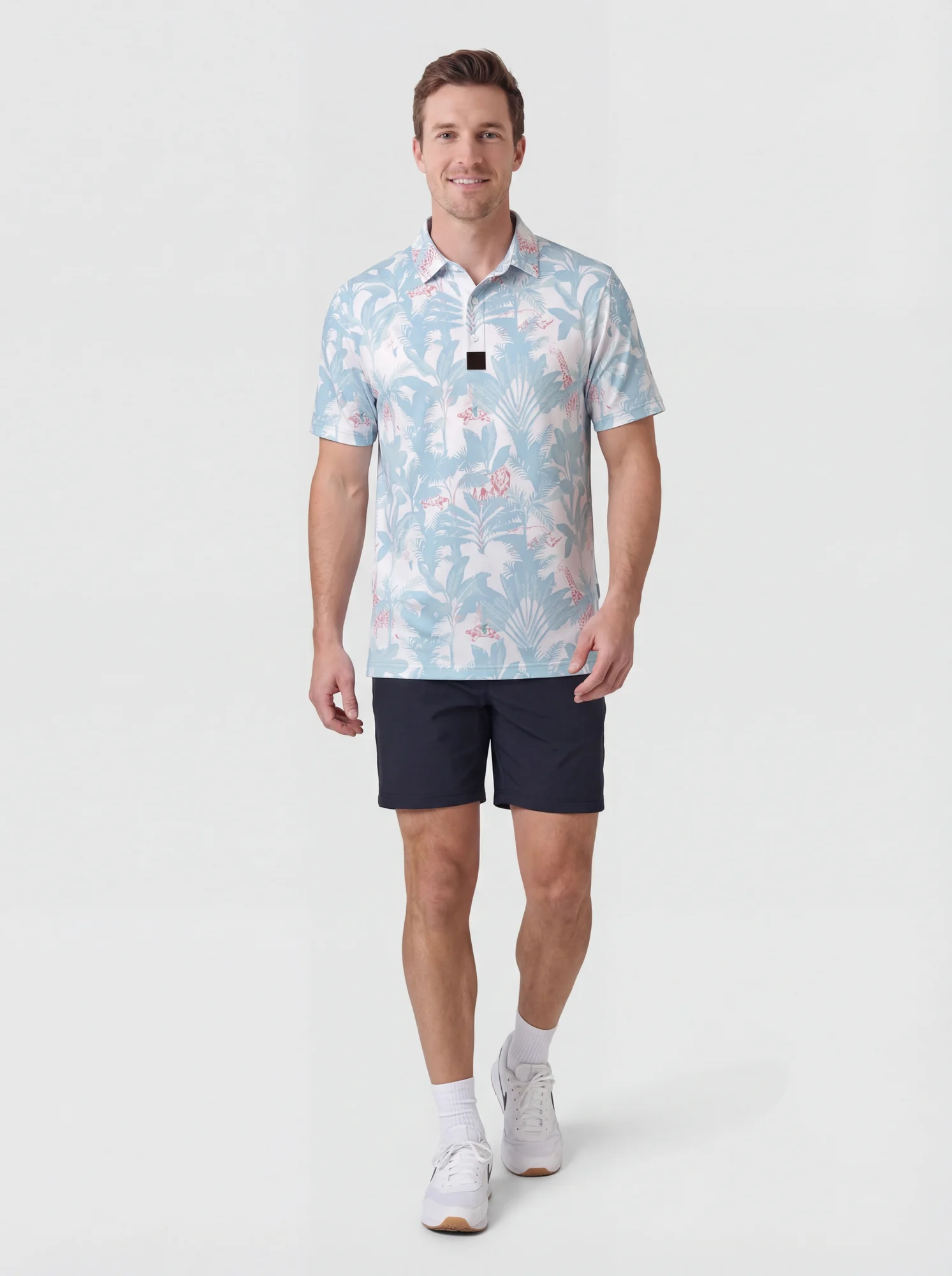 Men's powder blue tropical print polo in powder blue / white / pink, full-length styling view