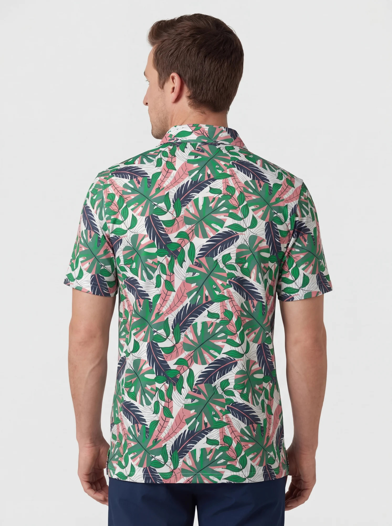 Men's green tropical foliage polo in white / green / pink, back view