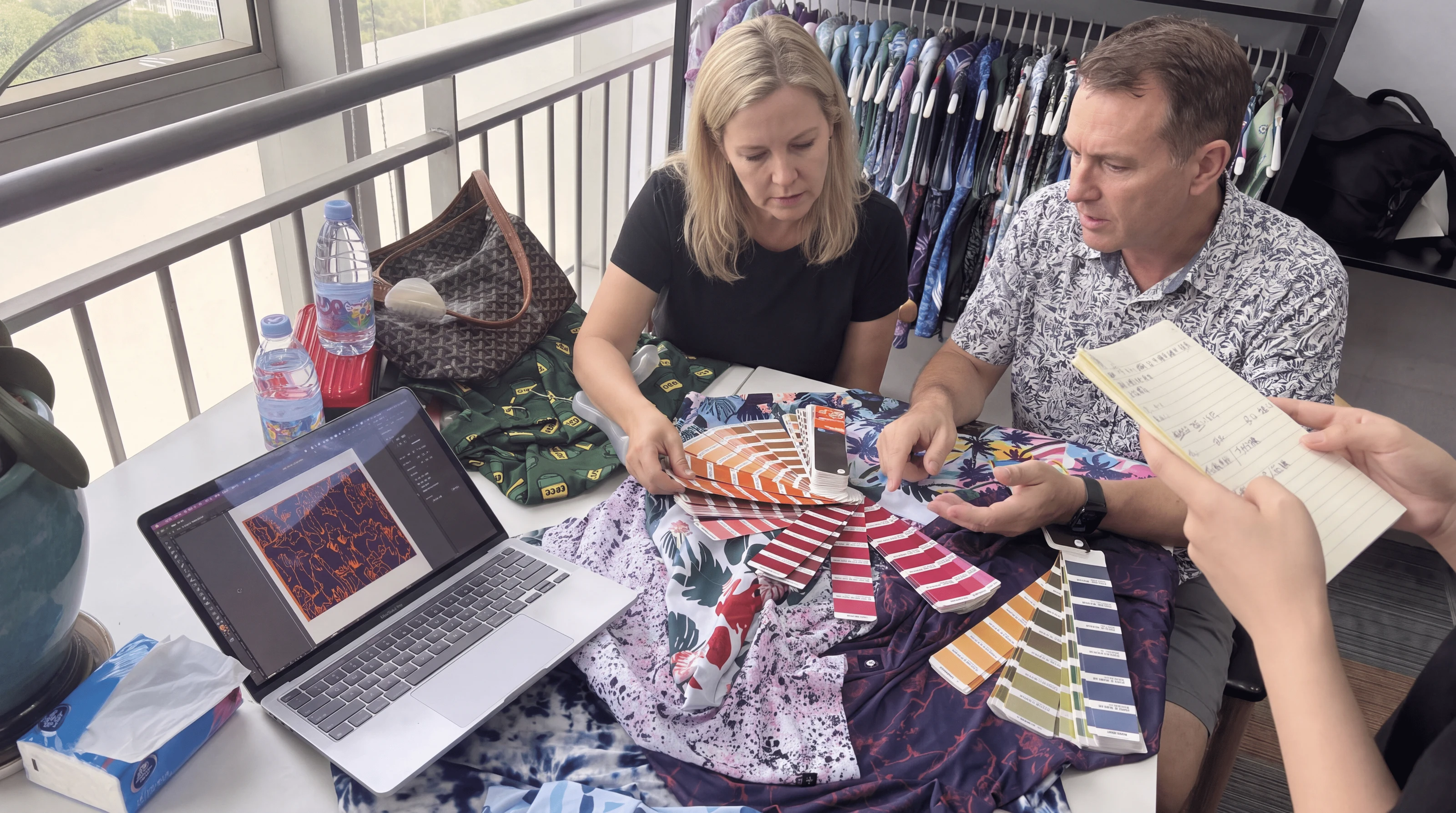 Golf apparel development meeting with fabric and print swatches