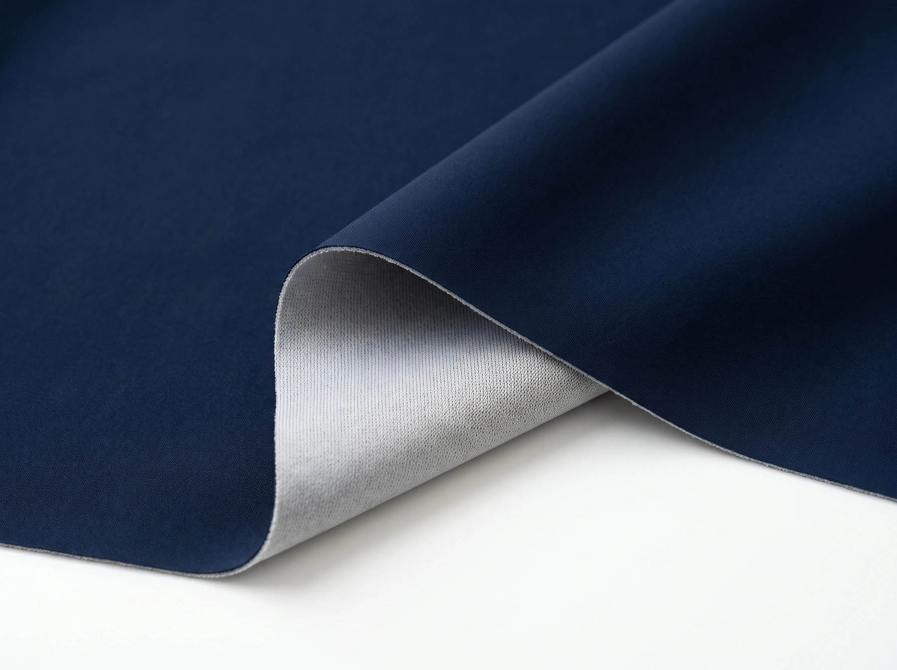 Thin navy stretch-woven bonded fabric with a fine lightweight grey tricot backing